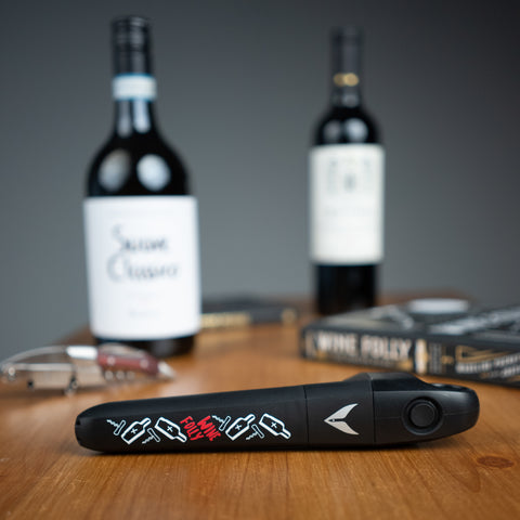 Coravin Pivot (Wine Folly Art Edition) on a table with wine